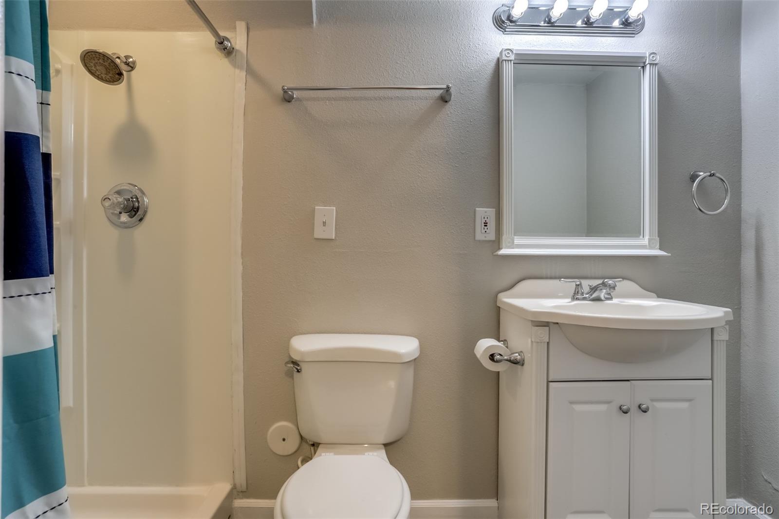 514 Longfellow Lane Highlands Ranch, CO 80126 - Photo 15 of 43 a bathroom with a sink a toilet and shower