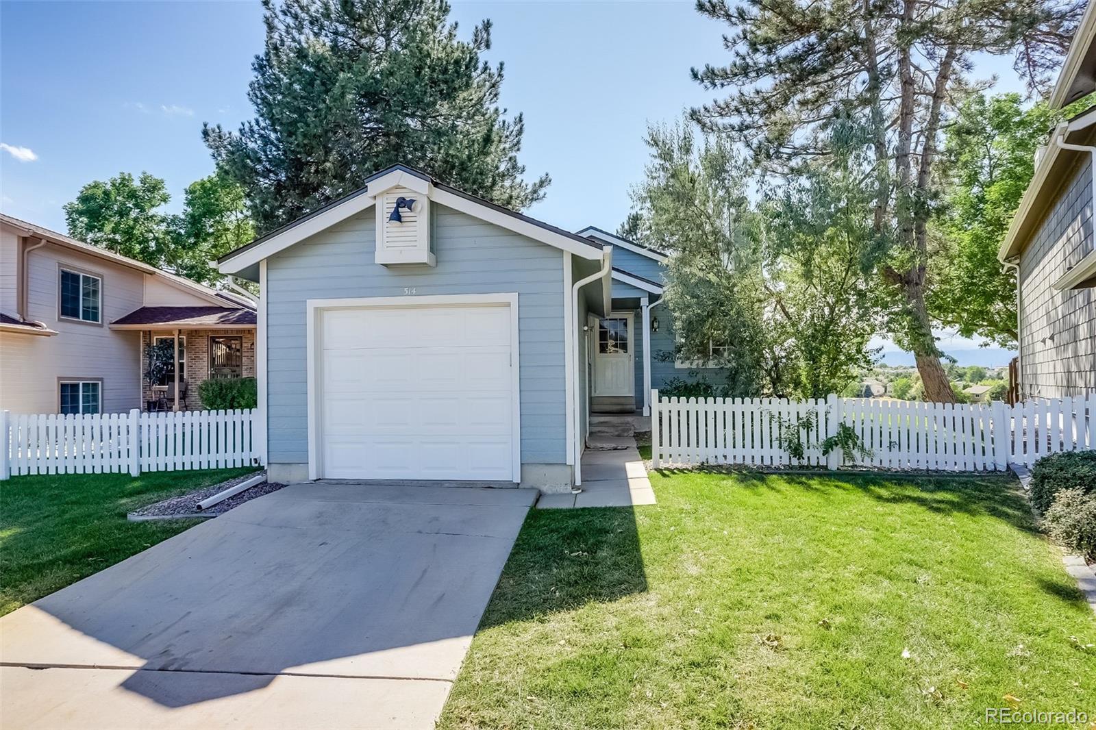514 Longfellow Lane Highlands Ranch, CO 80126 - Photo 3 of 43 a view of a front of a house with a yard potted plants and large tree