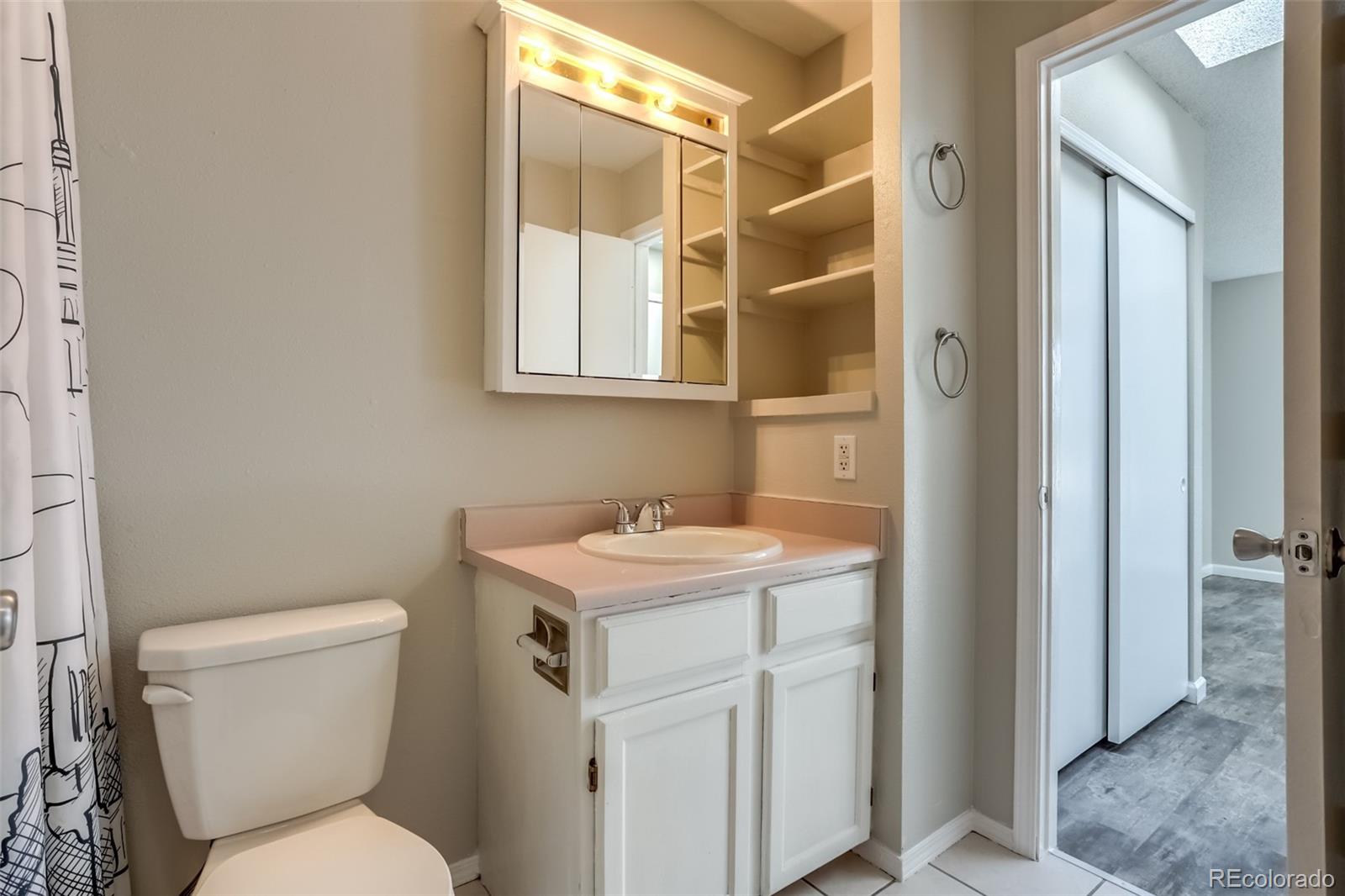 514 Longfellow Lane Highlands Ranch, CO 80126 - Photo 32 of 43 a bathroom with a toilet sink and mirror