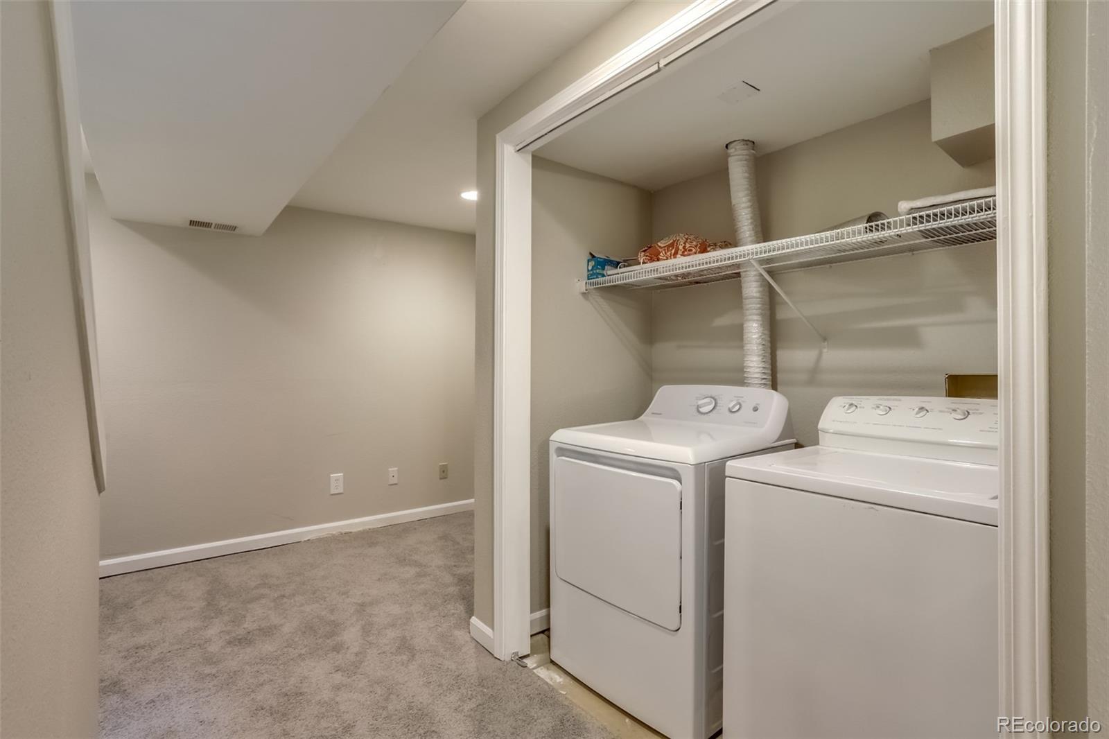514 Longfellow Lane Highlands Ranch, CO 80126 - Photo 34 of 43 a view of storage and utility room with washer and dryer