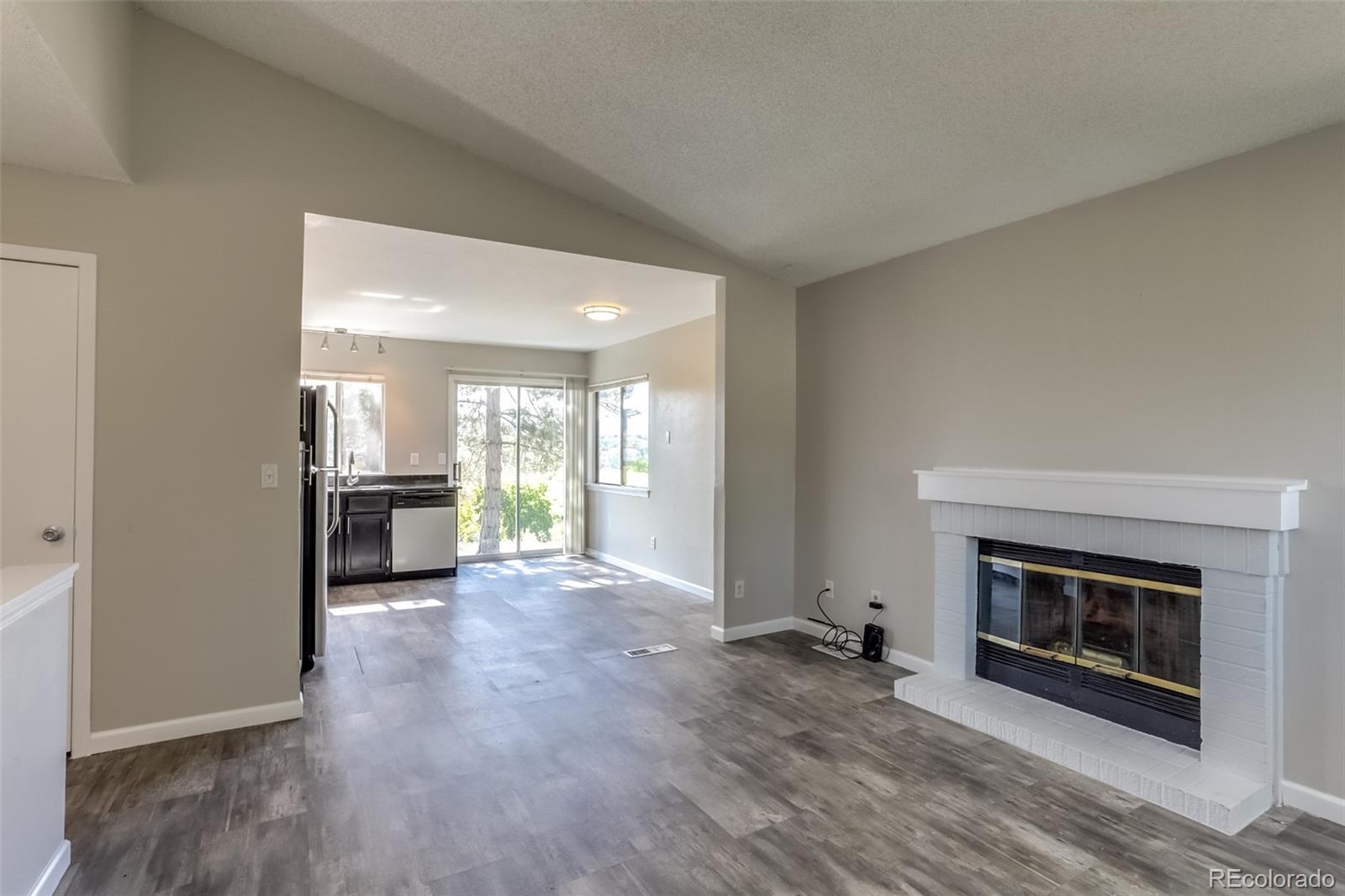 514 Longfellow Lane Highlands Ranch, CO 80126 - Photo 7 of 43 a view of a hallway with a fireplace and a window