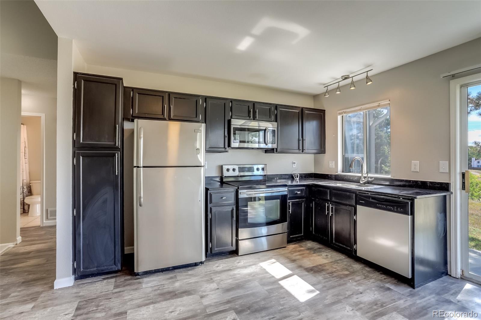 514 Longfellow Lane Highlands Ranch, CO 80126 - Photo 8 of 43 a kitchen with stainless steel appliances granite countertop a refrigerator stove a sink and a granite counter tops