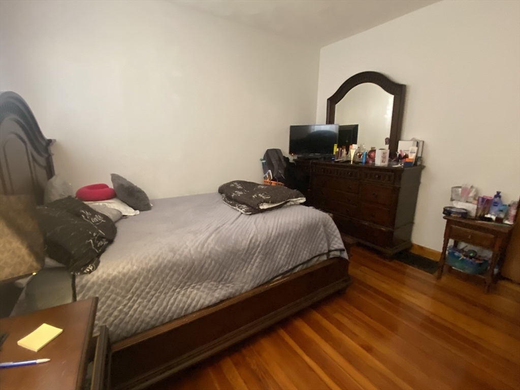 9 Starbird Street, Unit 1 Malden, MA 02148 - Photo 5 of 6 a bedroom with a bed and a dresser