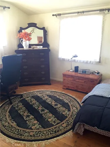 a bed sitting in a bedroom next to a window