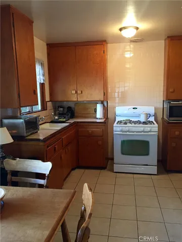 a kitchen with stainless steel appliances a stove a sink and a microwave
