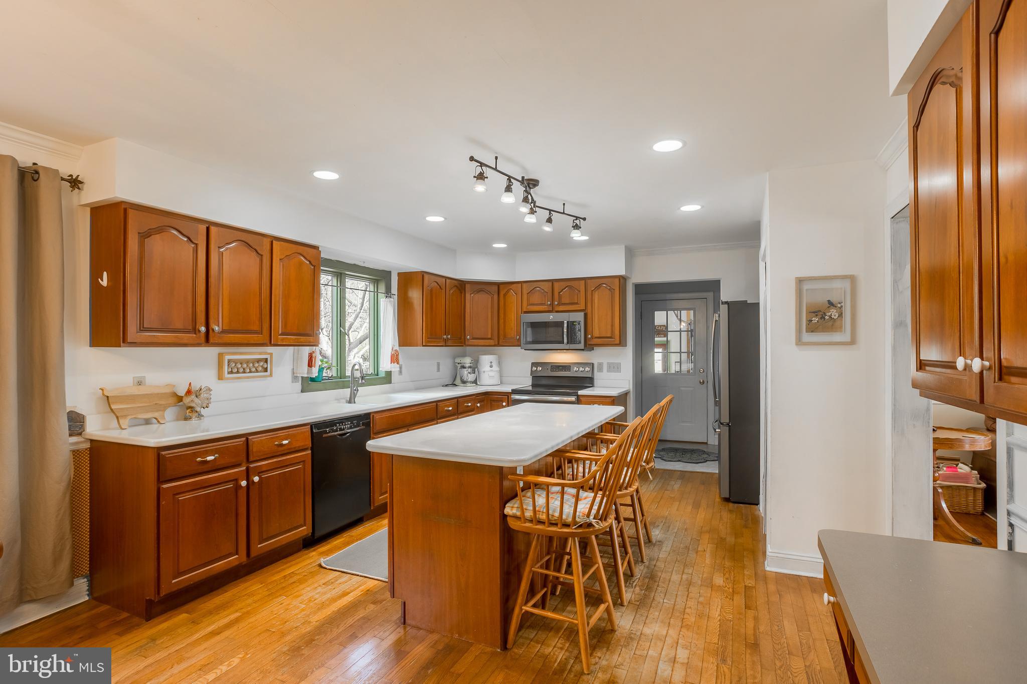 7904 Clark Road Denton, MD 21629 - Photo 13 of 71 a kitchen with stainless steel appliances granite countertop a table chairs sink and cabinets