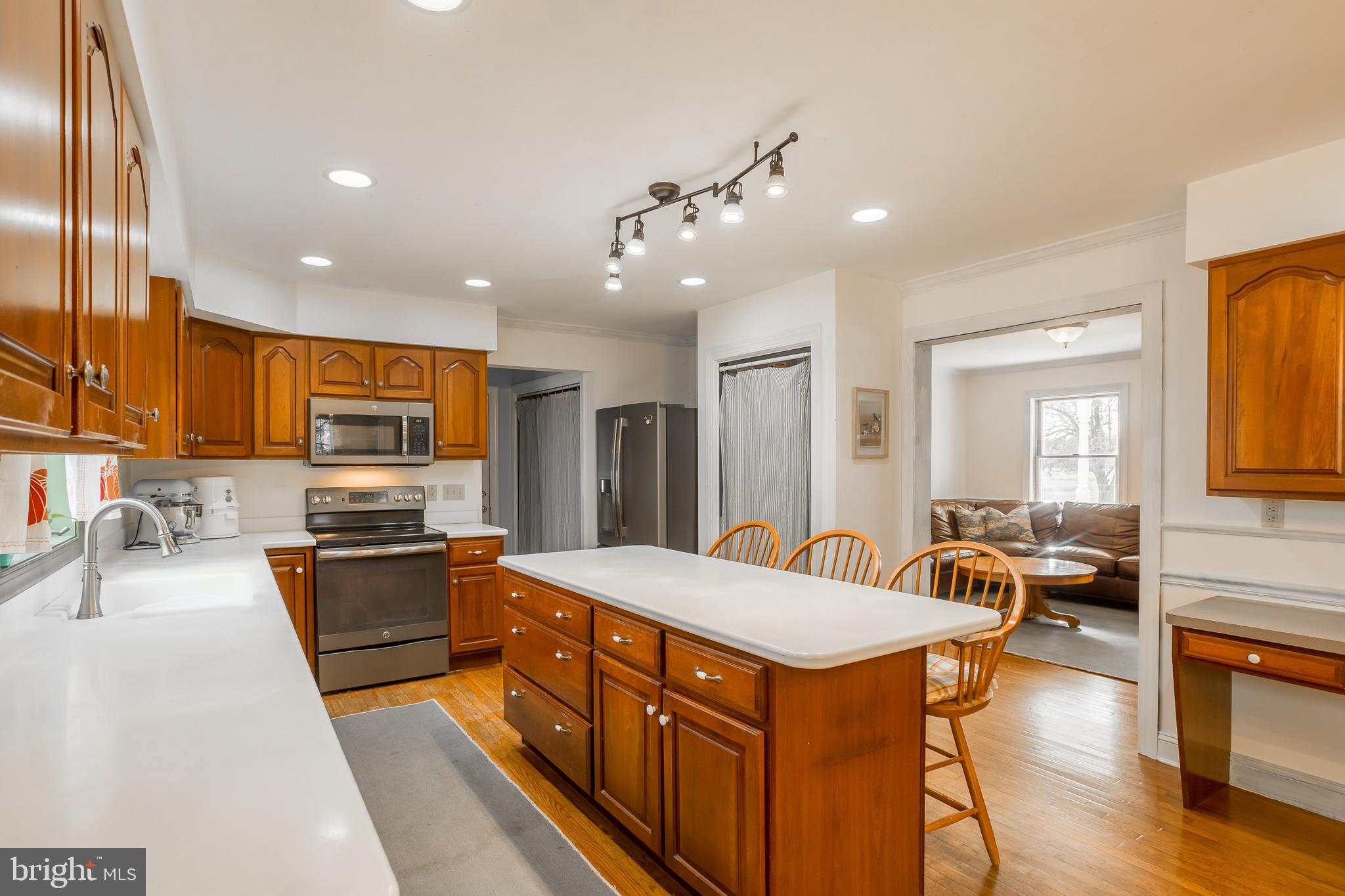 7904 Clark Road Denton, MD 21629 - Photo 14 of 71 a kitchen with stainless steel appliances granite countertop a sink stove and refrigerator