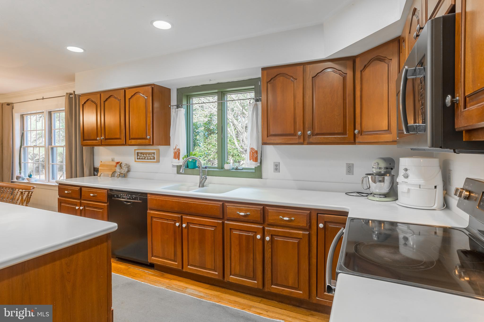 7904 Clark Road Denton, MD 21629 - Photo 17 of 71 a kitchen with stainless steel appliances granite countertop wooden cabinets a sink and a stove