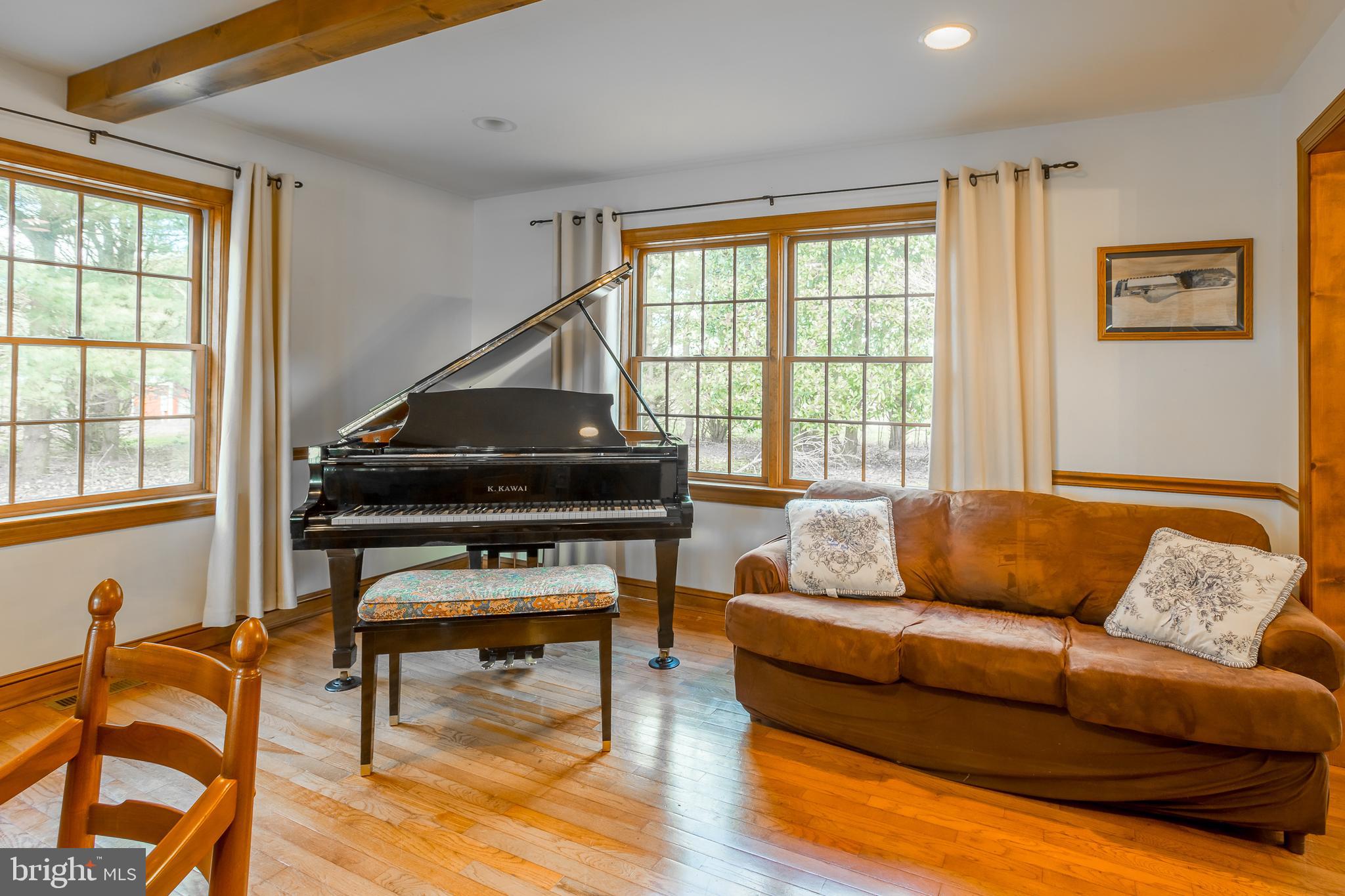 7904 Clark Road Denton, MD 21629 - Photo 24 of 71 a living room with furniture and a wooden floor