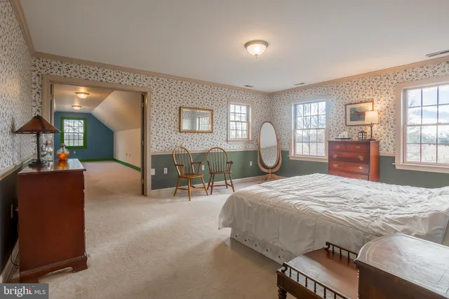 a bedroom with furniture and a window