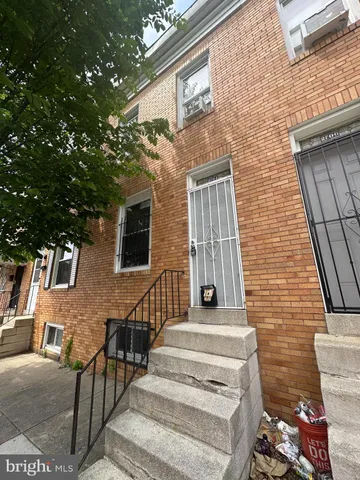 a view of a brick house with many windows