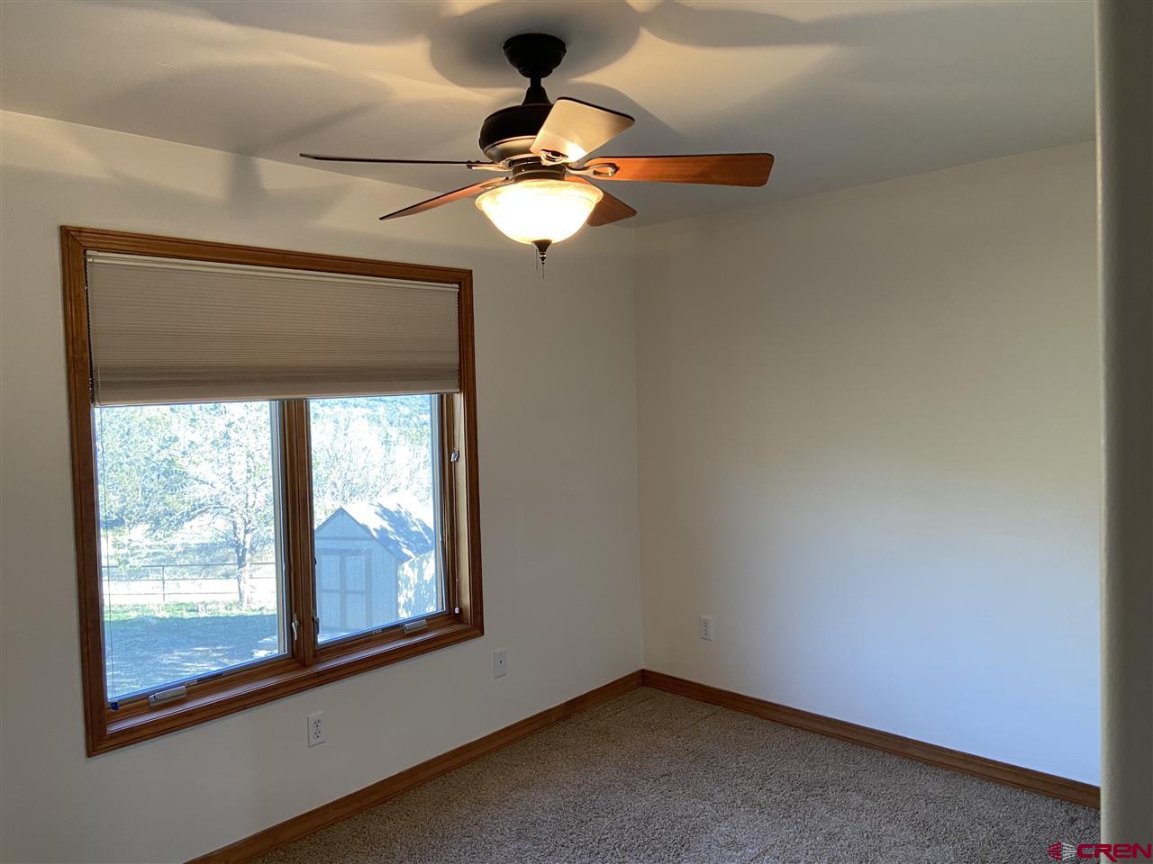 18181 Hanson Road Cedaredge, CO 81413 - Photo 18 of 23 Nicely sized bedroom with a large closet, overlooking the back yard.