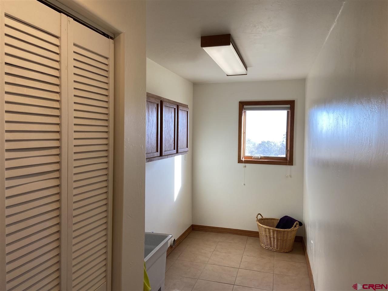 18181 Hanson Road Cedaredge, CO 81413 - Photo 20 of 23 large laundry with sink and plenty of storage