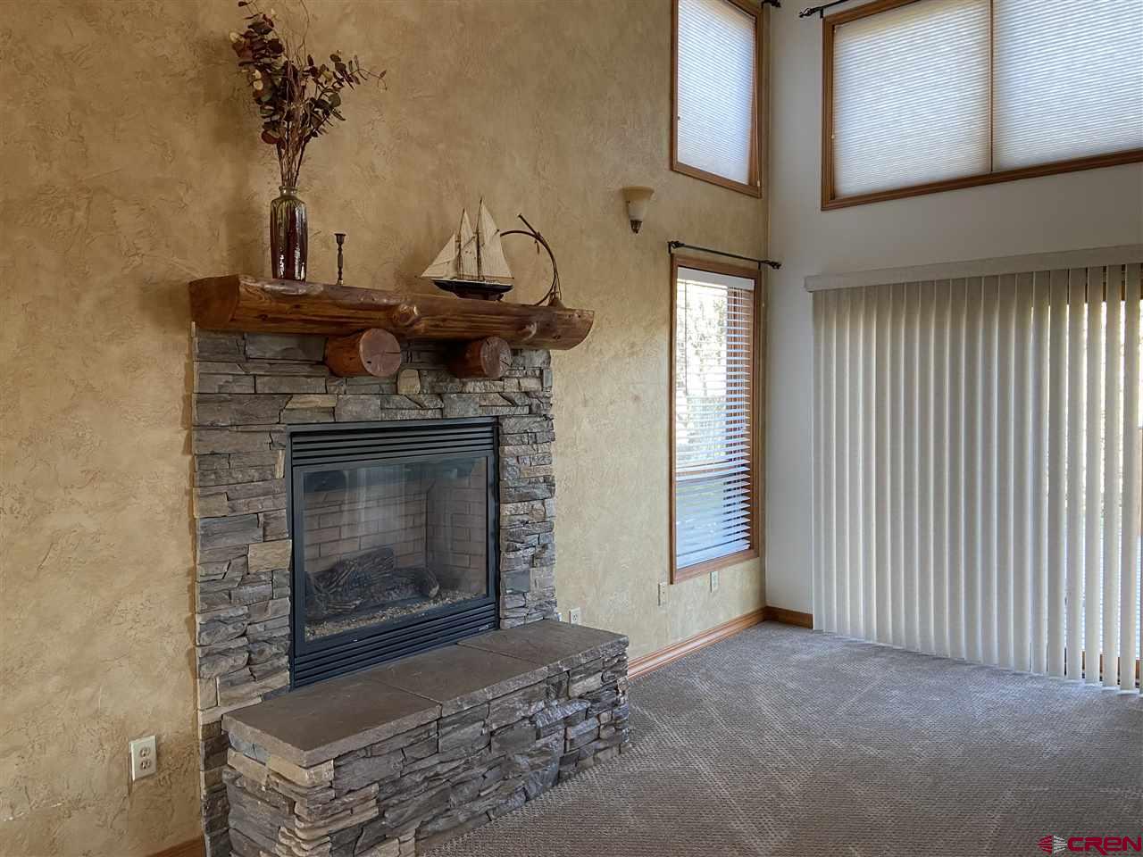 18181 Hanson Road Cedaredge, CO 81413 - Photo 6 of 23 Gas fireplace with stone accents