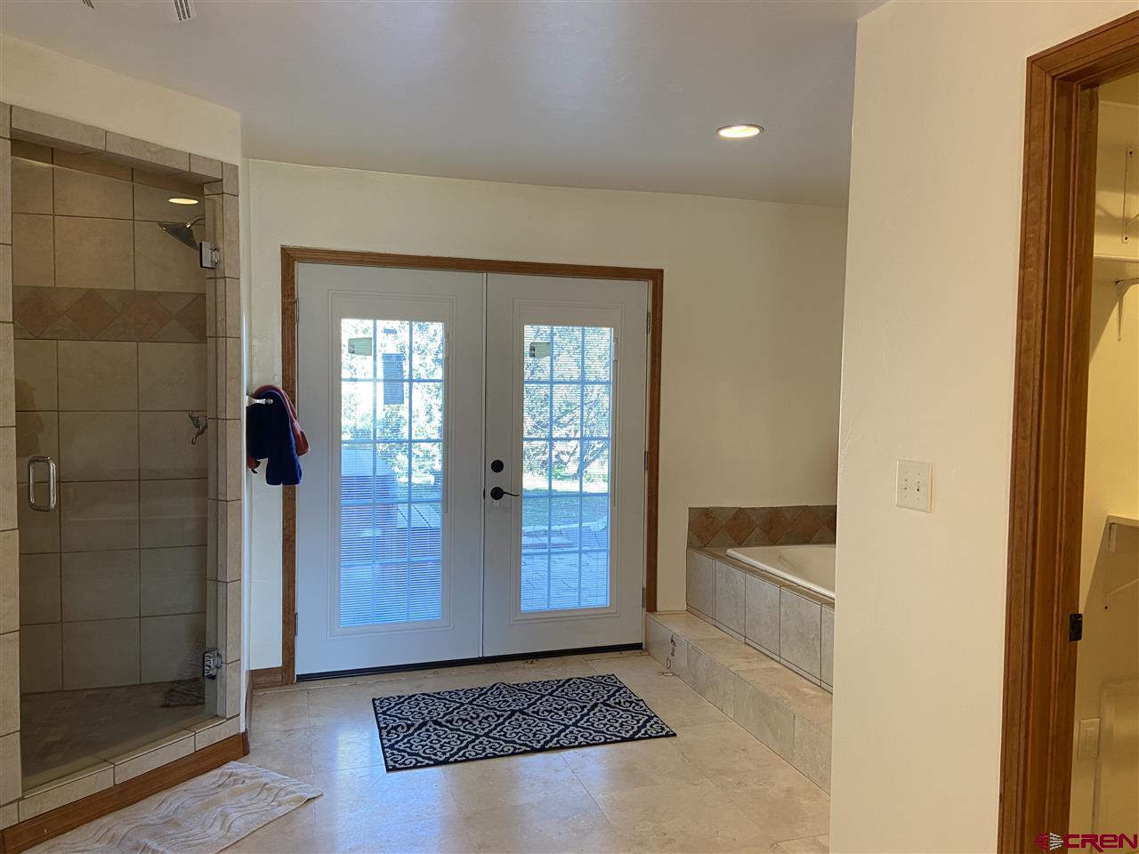 18181 Hanson Road Cedaredge, CO 81413 - Photo 10 of 23 New french doors lead to the hot tub and back yard