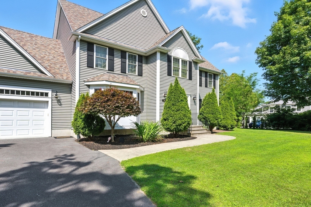30 Neponset Street Walpole, MA 02071 - Photo 31 of 41 a front view of a house with a yard and garage