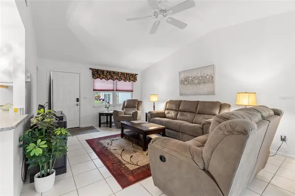a living room with furniture and a potted plant