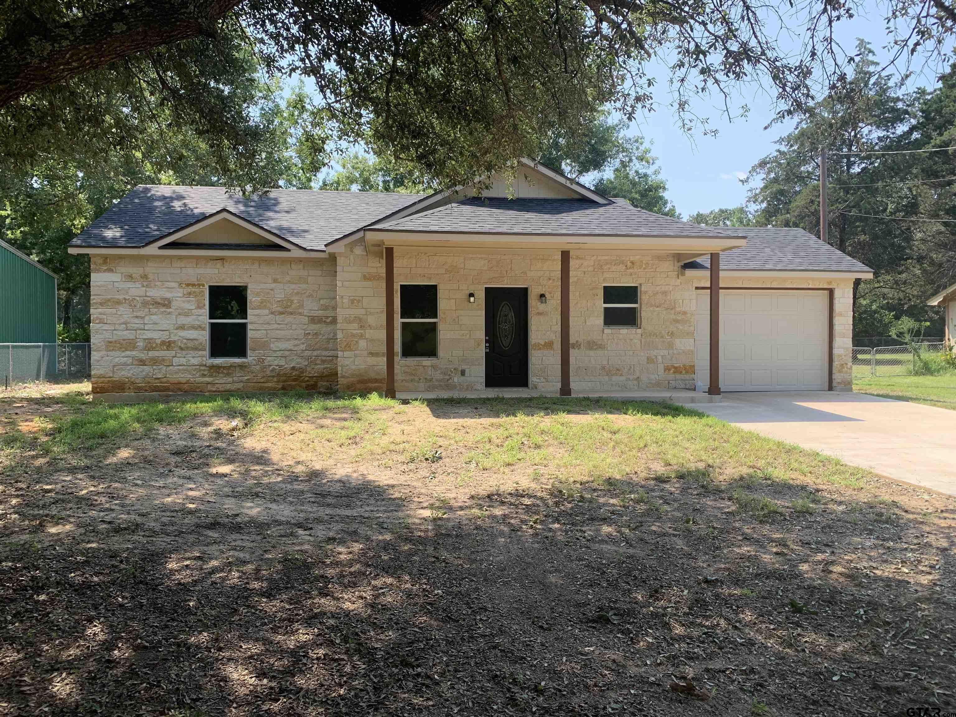 10731 Circle Point Frankston, TX 75763 - Photo 1 of 13 a front view of a house with a yard and garage