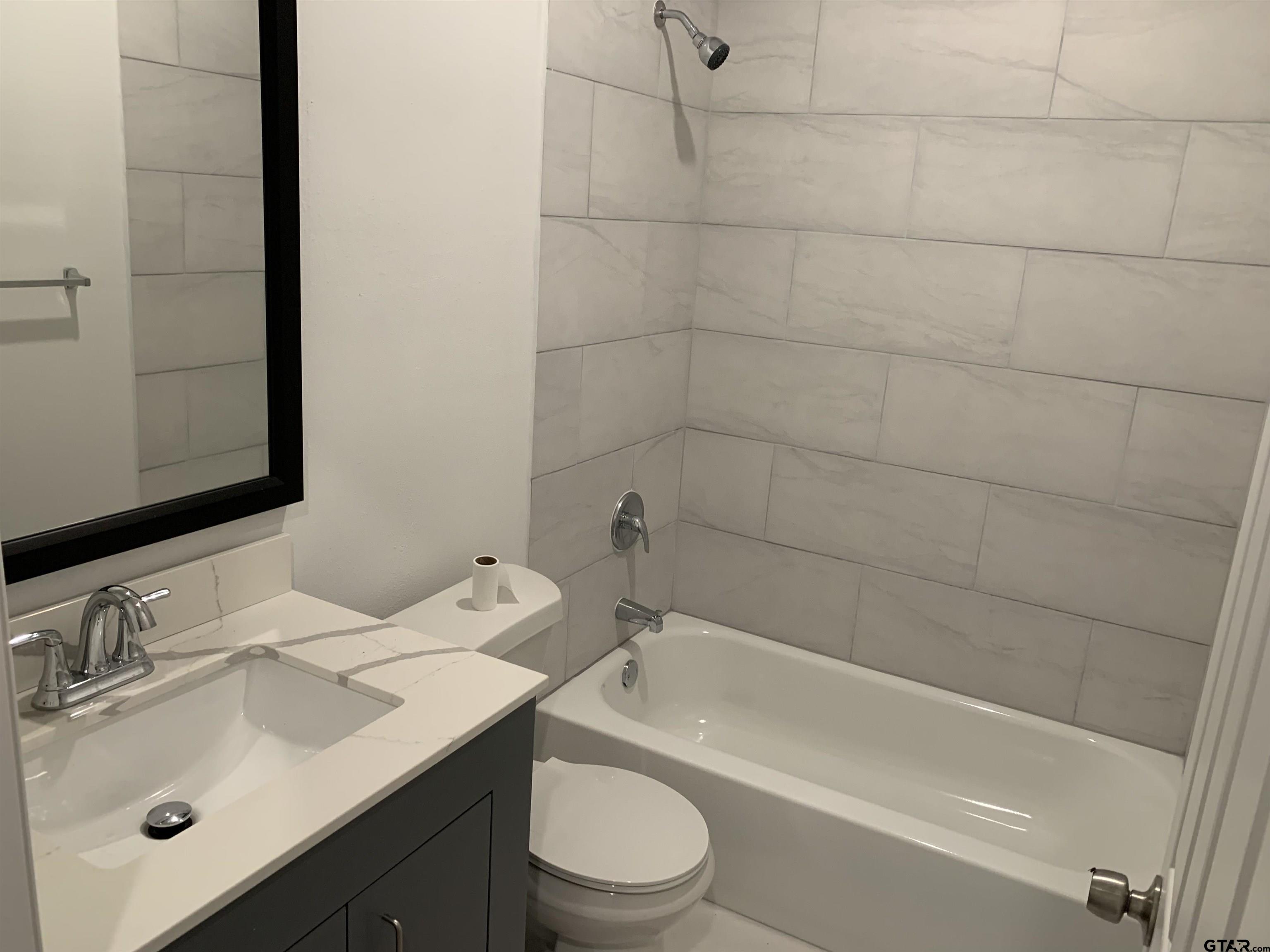 10731 Circle Point Frankston, TX 75763 - Photo 11 of 13 a bathroom with a sink toilet a mirror and shower