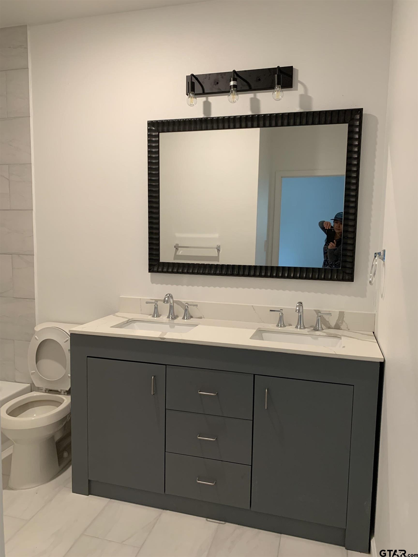 10731 Circle Point Frankston, TX 75763 - Photo 8 of 13 a bathroom with a toilet sink and mirror
