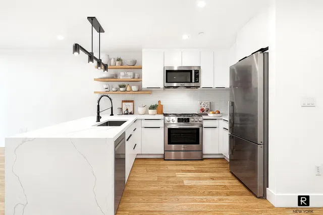 a kitchen with stainless steel appliances a refrigerator stove and sink