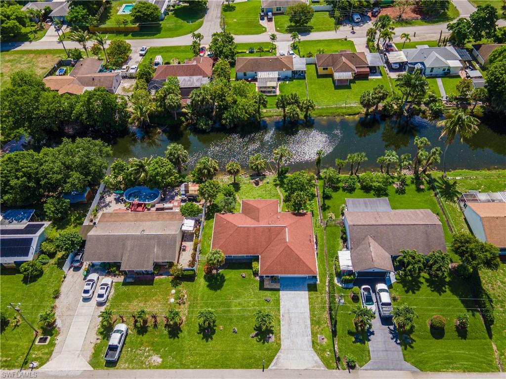 2100 55th Street Southwest Naples, FL 34116 - Photo 30 of 50 an aerial view of house with yard swimming pool and outdoor seating