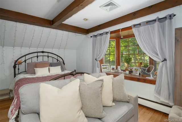 a bedroom with a bed and a large window