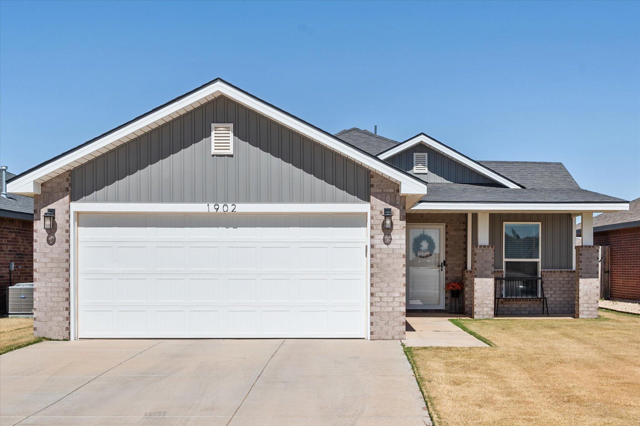 1902 137th Street Lubbock, TX 79423 - Photo 1 of 27 a front view of a house with a garage
