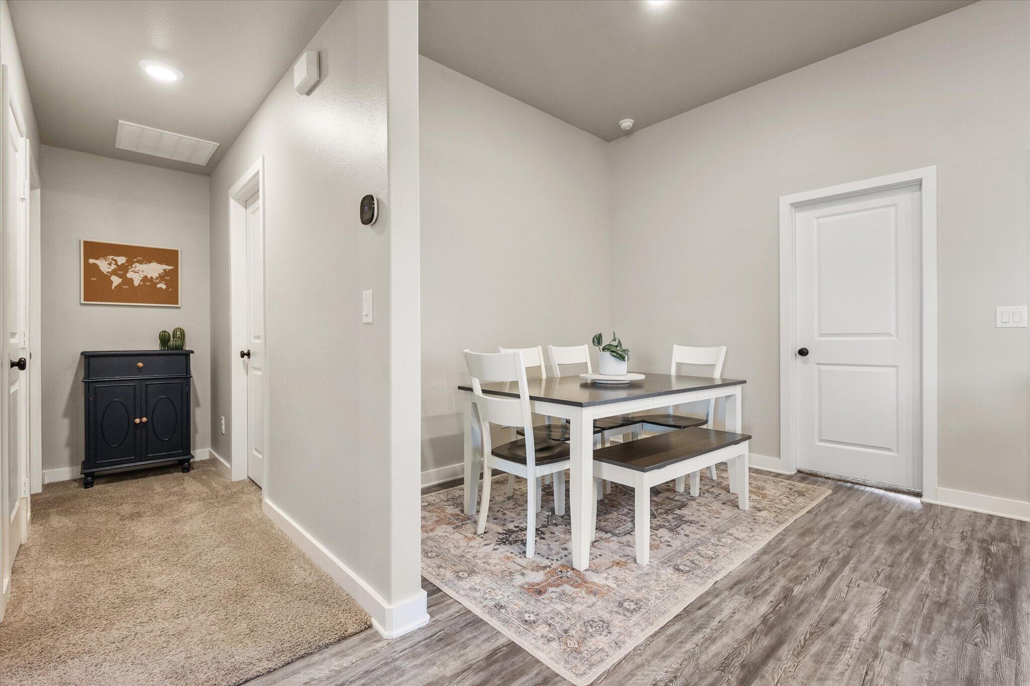 1902 137th Street Lubbock, TX 79423 - Photo 16 of 27 a dining room with furniture and wooden floor
