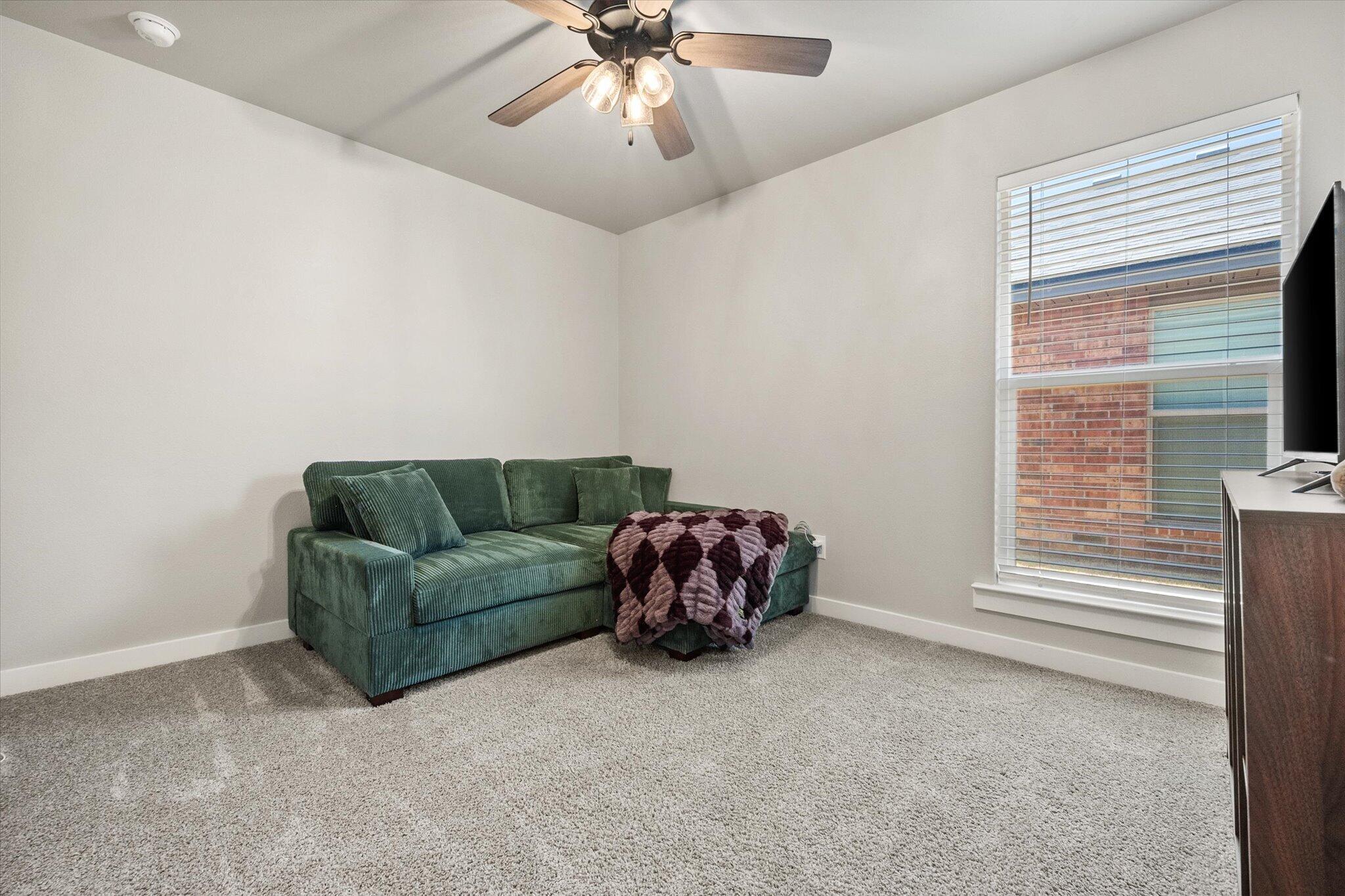 1902 137th Street Lubbock, TX 79423 - Photo 18 of 27 a living room with furniture and a window