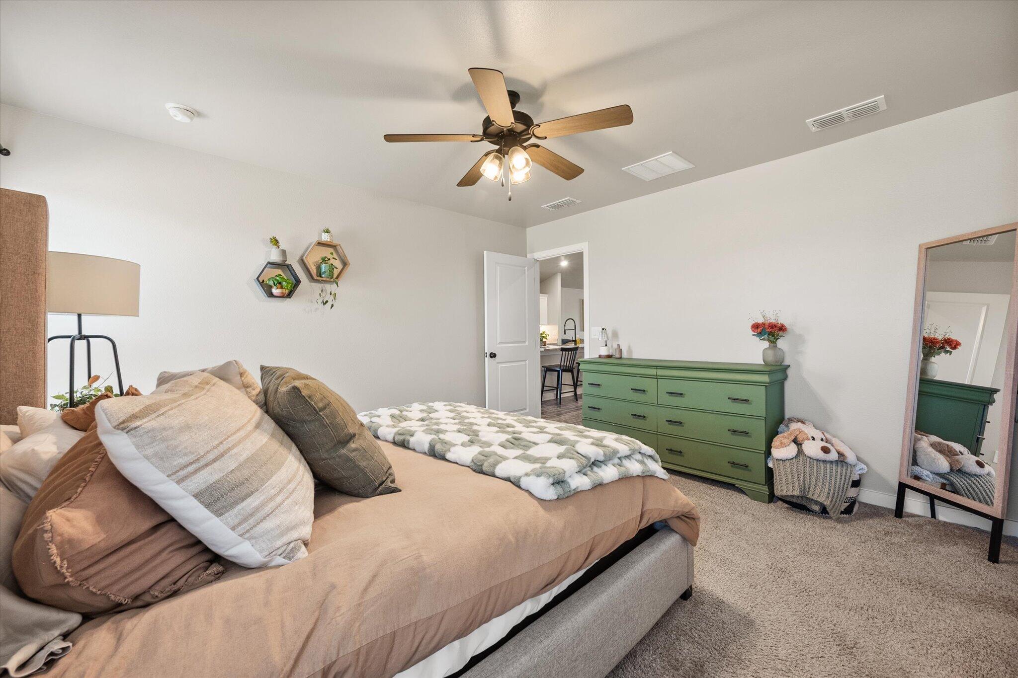 1902 137th Street Lubbock, TX 79423 - Photo 20 of 27 a bedroom with a bed and ceiling fan