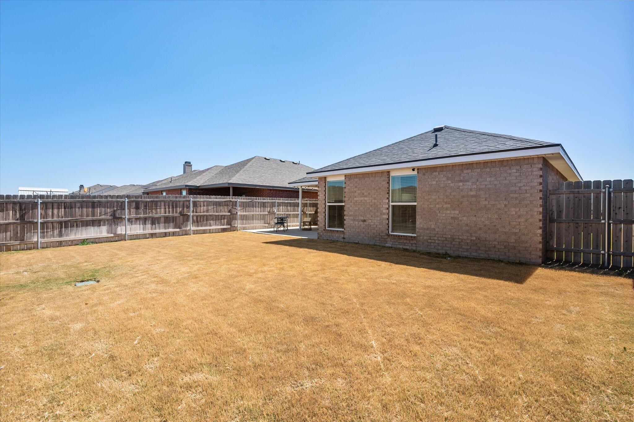 1902 137th Street Lubbock, TX 79423 - Photo 26 of 27 a front view of a house with a yard