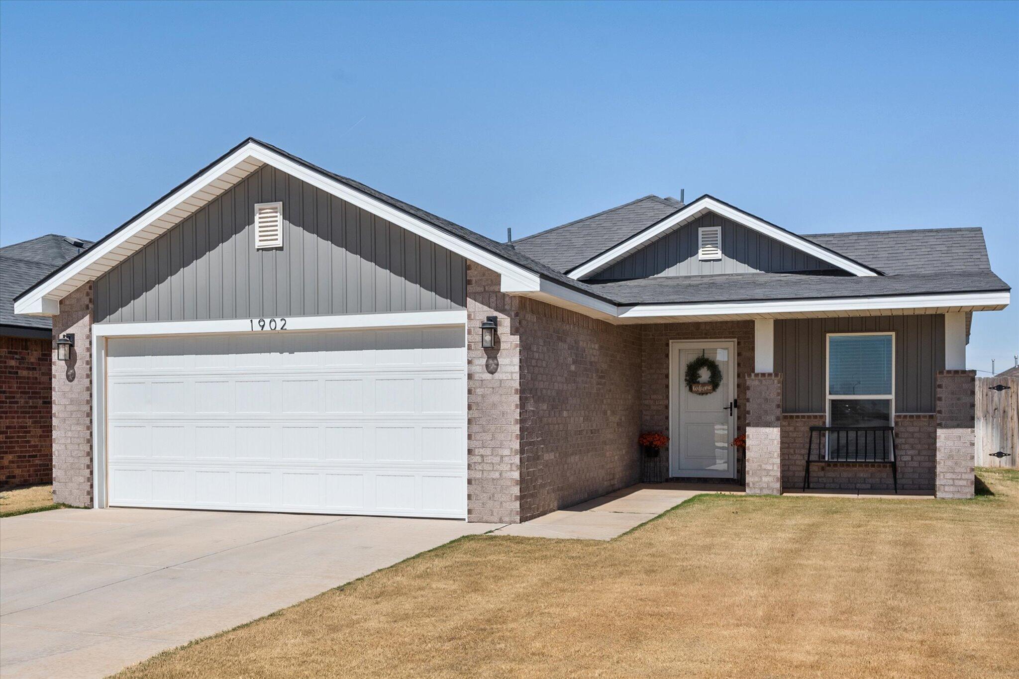 1902 137th Street Lubbock, TX 79423 - Photo 4 of 27 a front view of a house with a garage