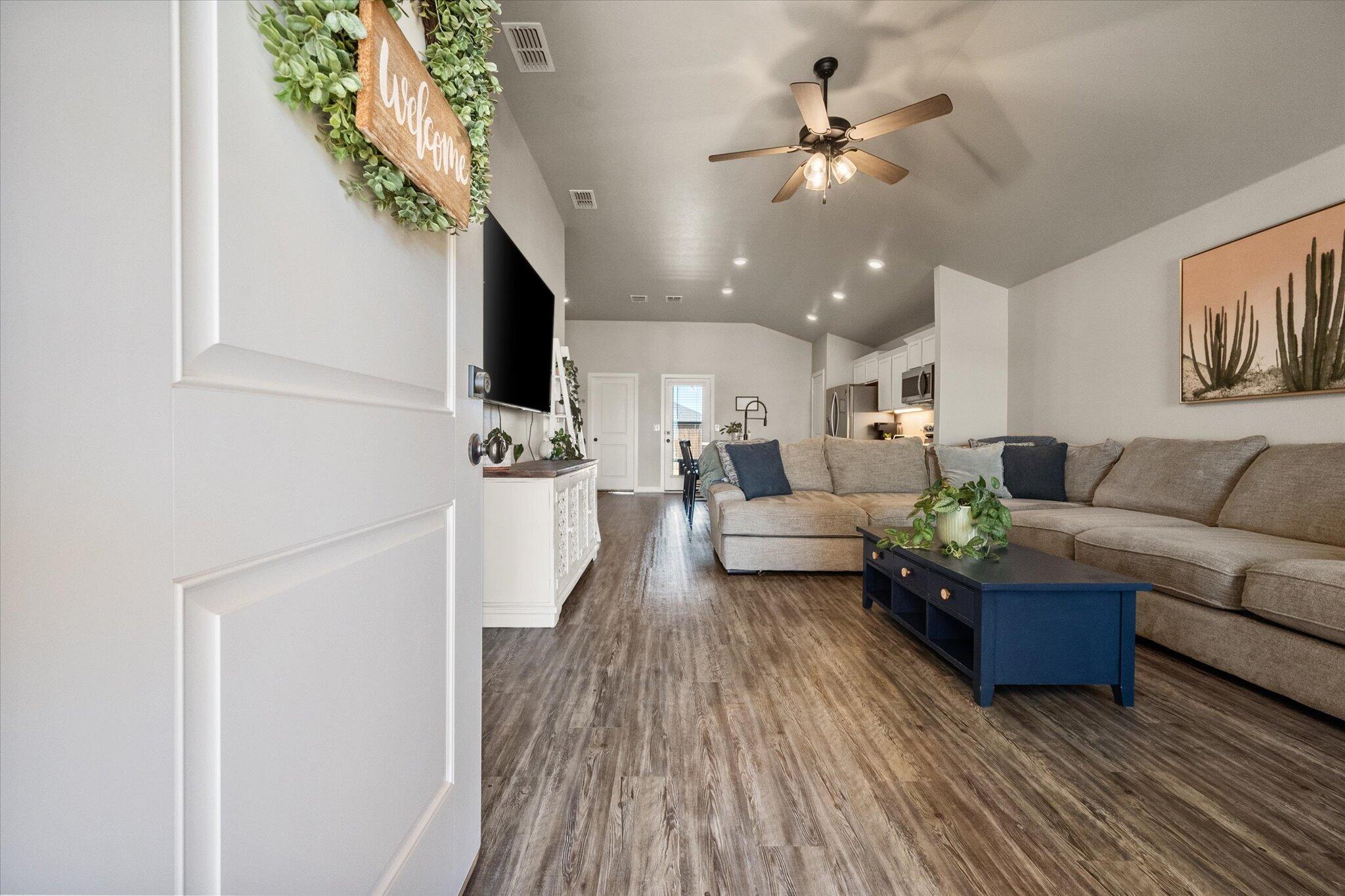 1902 137th Street Lubbock, TX 79423 - Photo 6 of 27 a living room with furniture and a chandelier