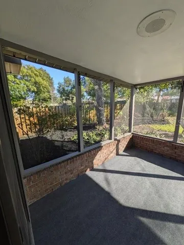 a room with a large window and bed