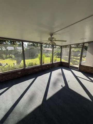 wooden floor in an empty room with large windows