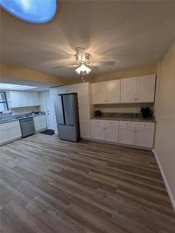 a view of a kitchen with electric appliances