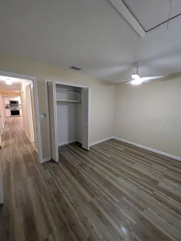 a view of a room with wooden floor