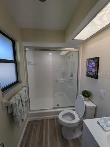 a bathroom with a granite countertop toilet sink and shower