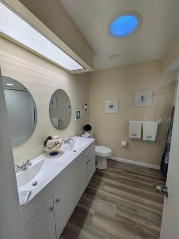 a bathroom with a double vanity sink and a mirror