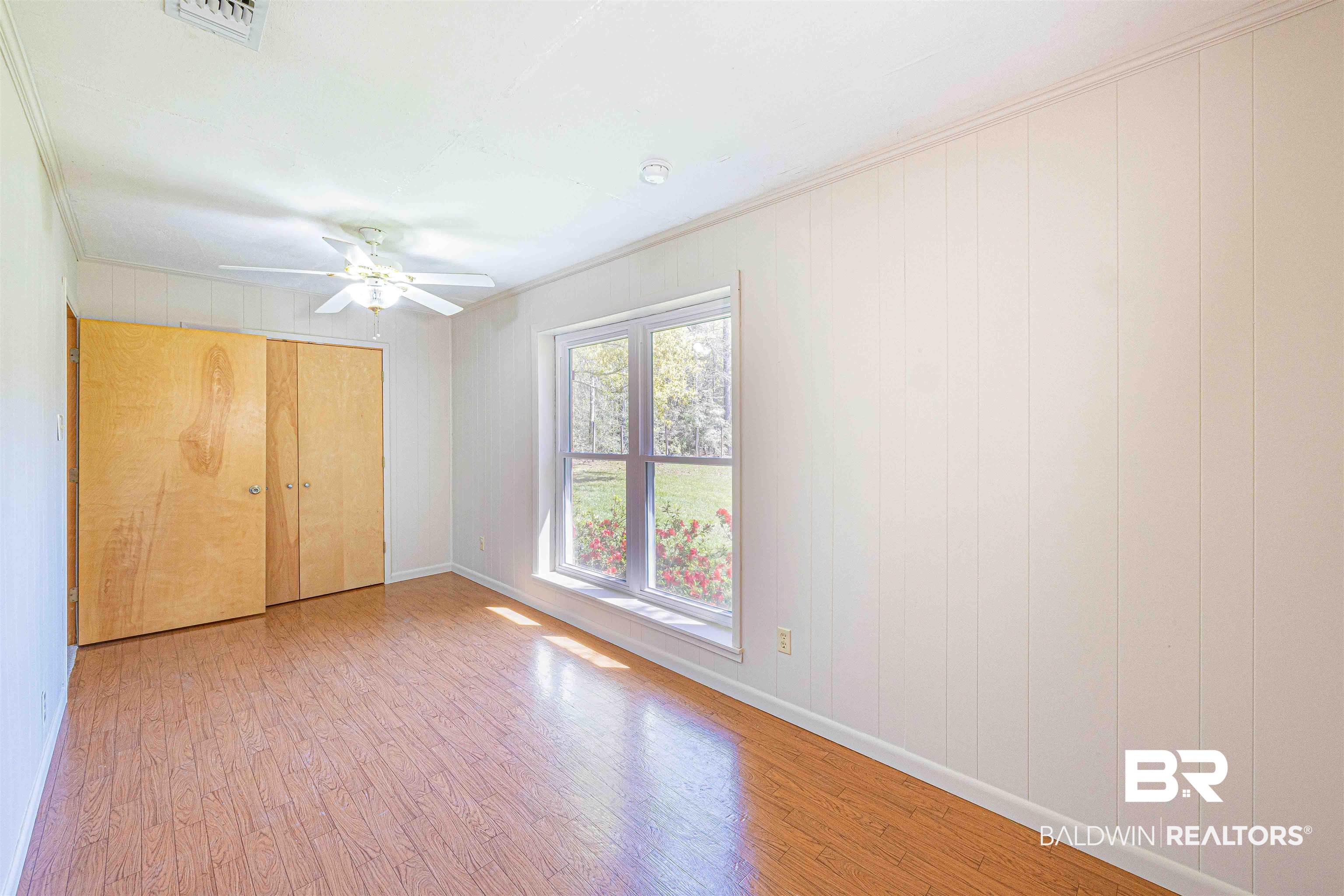 43101 Brown Road Bay Minette, AL 36507 - Photo 40 of 81 Unfurnished bedroom with light wood-type flooring, a closet, ceiling fan, and crown molding