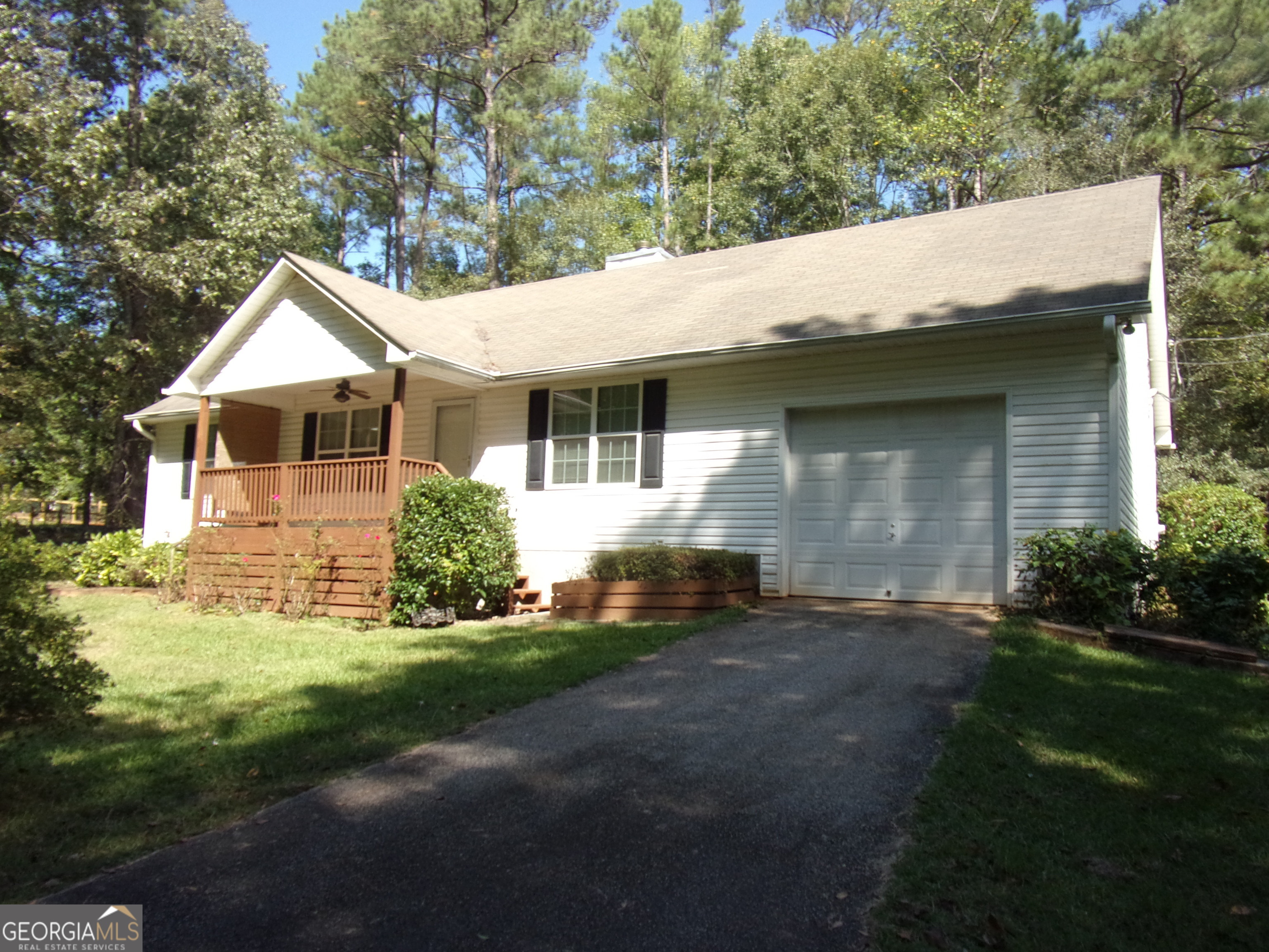 579 Lifsey Springs Road Molena, GA 30258 - Photo 1 of 1 a backyard of a house with plants and large tree