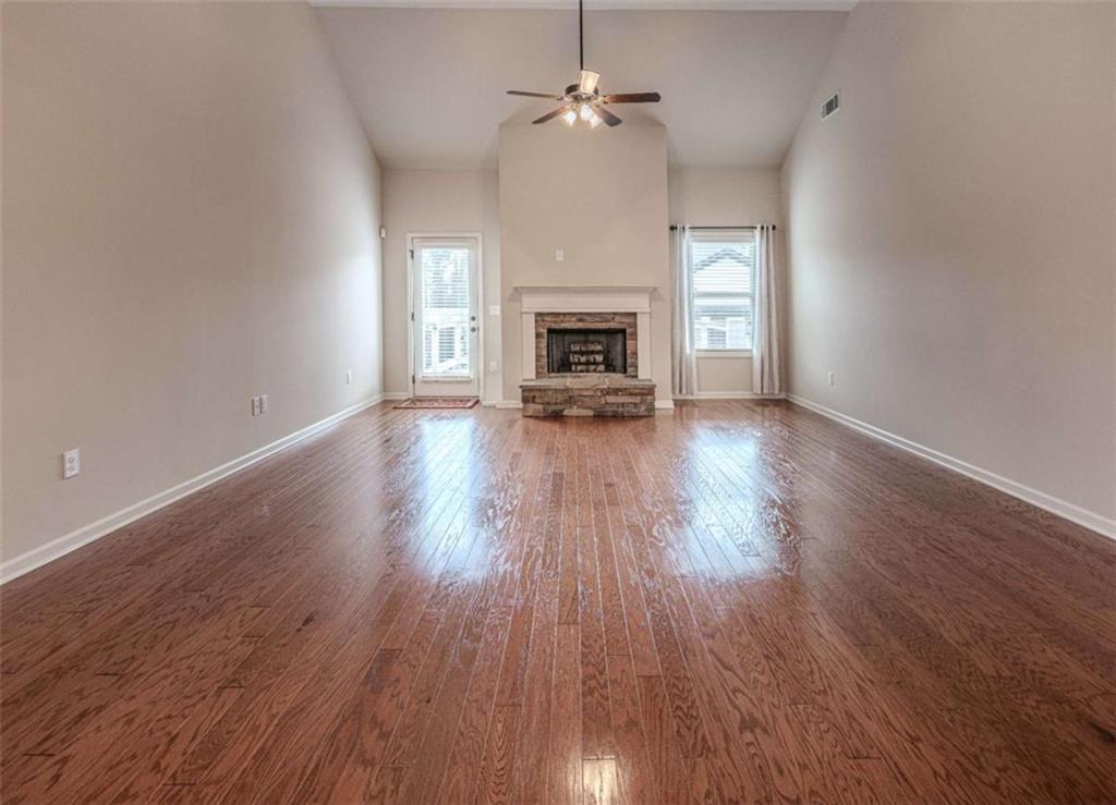 205 Heritage Stroll Athens, GA 30606 - Photo 11 of 30 an empty room with wooden floor fireplace and windows