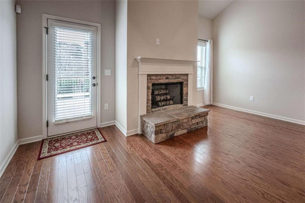 205 Heritage Stroll Athens, GA 30606 - Photo 14 of 30 a living room with wooden floors and a fireplace