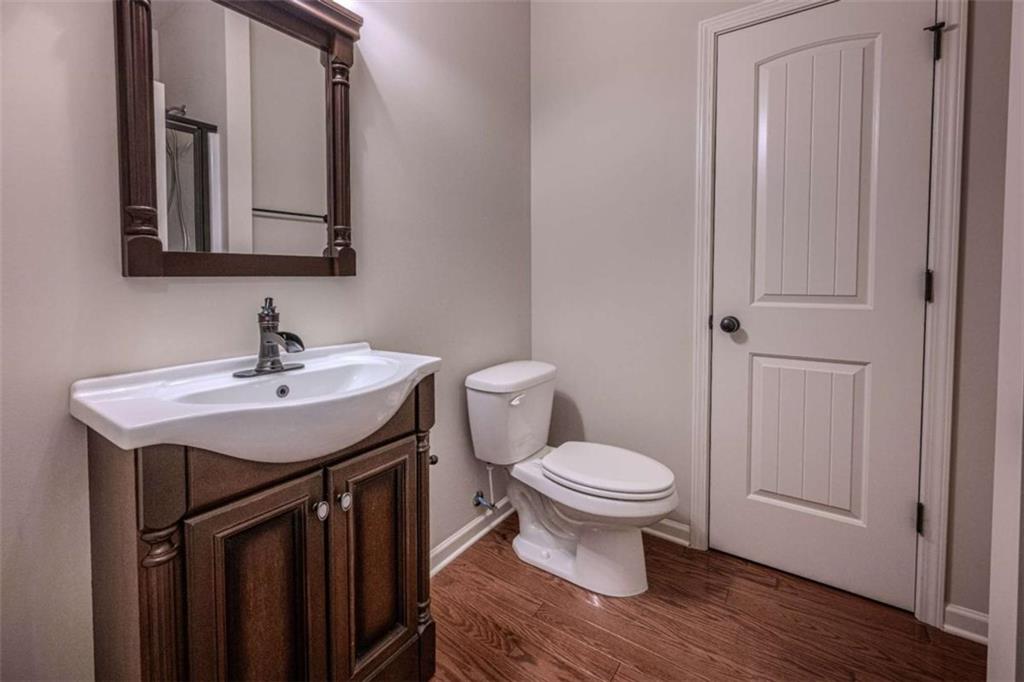 205 Heritage Stroll Athens, GA 30606 - Photo 15 of 30 a bathroom with a toilet a sink and mirror