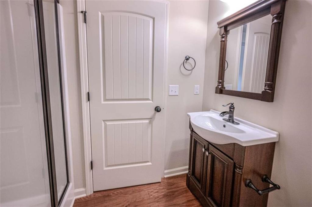 205 Heritage Stroll Athens, GA 30606 - Photo 17 of 30 a bathroom with a sink a mirror and a vanity