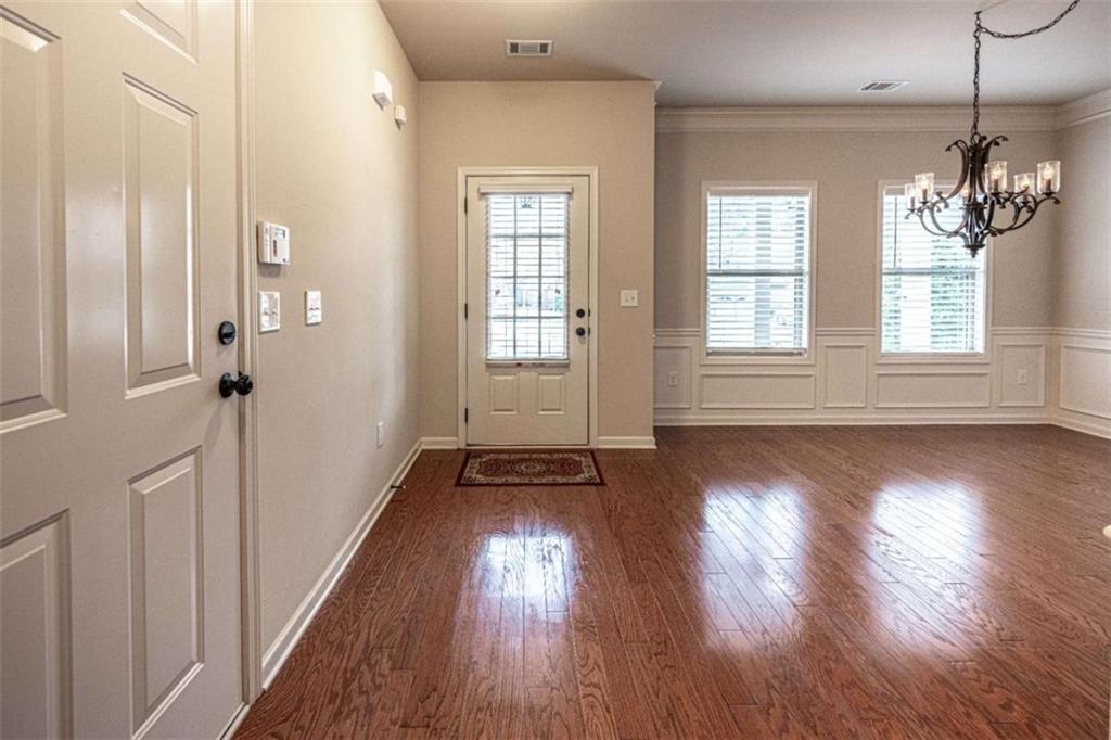 205 Heritage Stroll Athens, GA 30606 - Photo 2 of 30 an empty room with wooden floor and windows