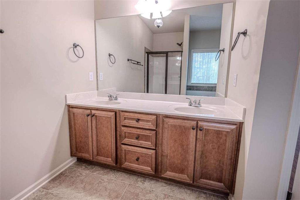 205 Heritage Stroll Athens, GA 30606 - Photo 23 of 30 a bathroom with a sink and a mirror