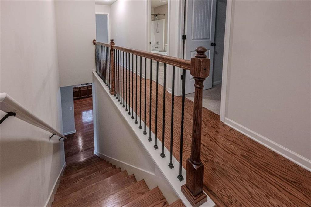 205 Heritage Stroll Athens, GA 30606 - Photo 24 of 30 a view of a hallway with wooden floor and staircase