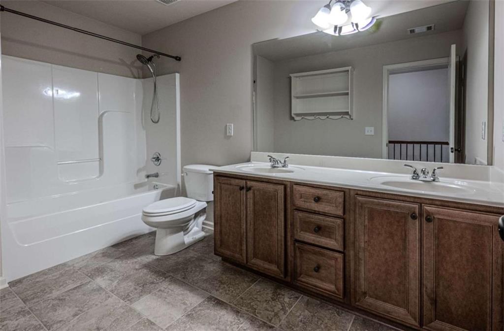 205 Heritage Stroll Athens, GA 30606 - Photo 26 of 30 a bathroom with a sink toilet double vanity and bathtub